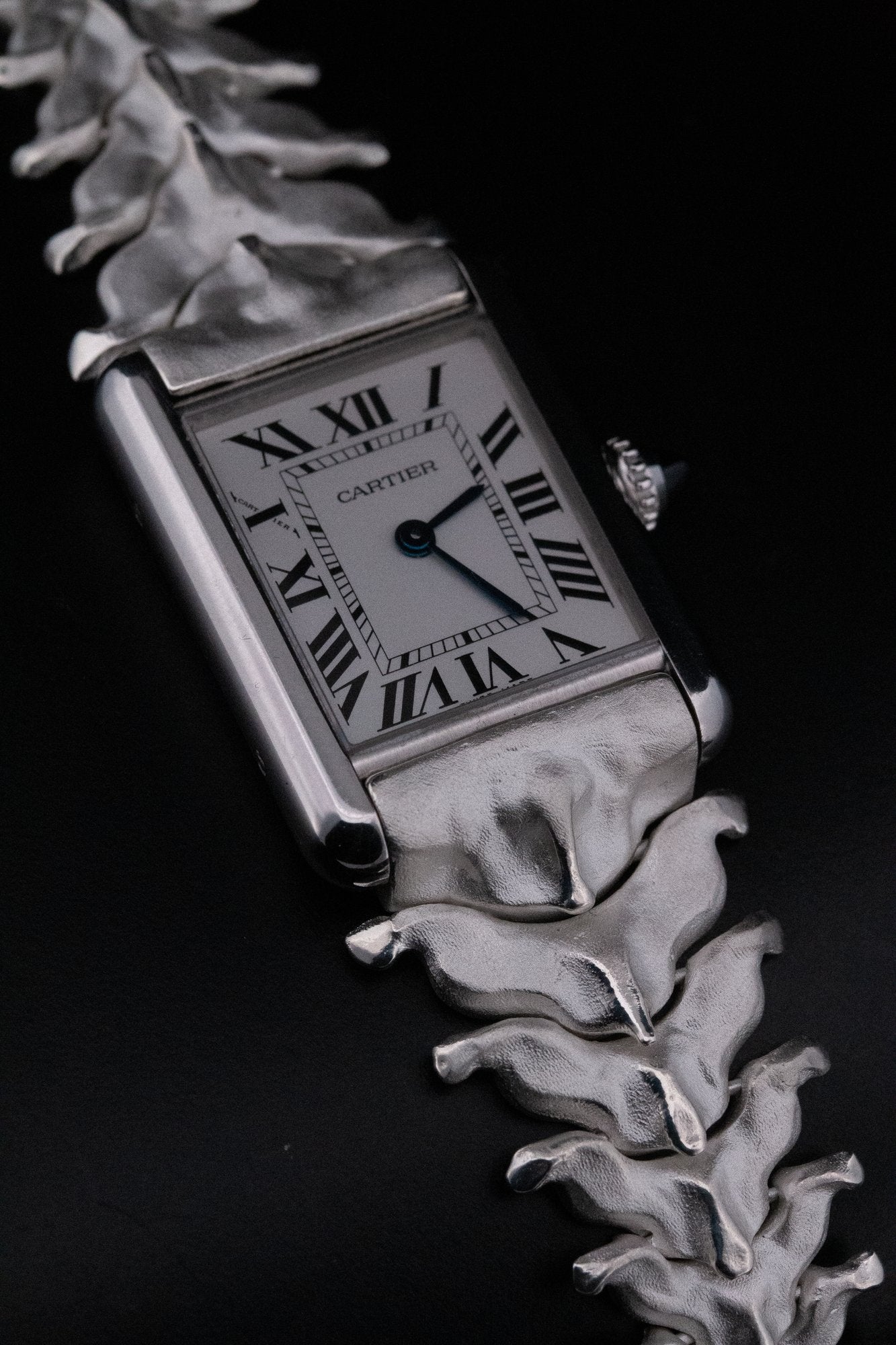 The Spinale vertebrae bracelet on a Cartier Tank